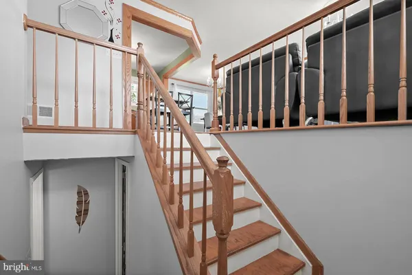 a view of staircase with wooden floor and a window