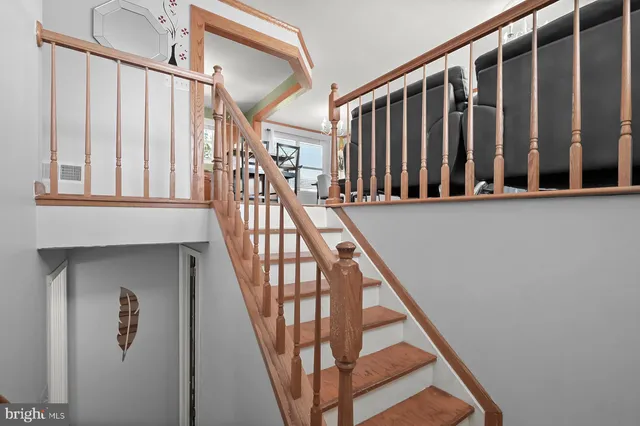 a view of staircase with wooden floor and a window