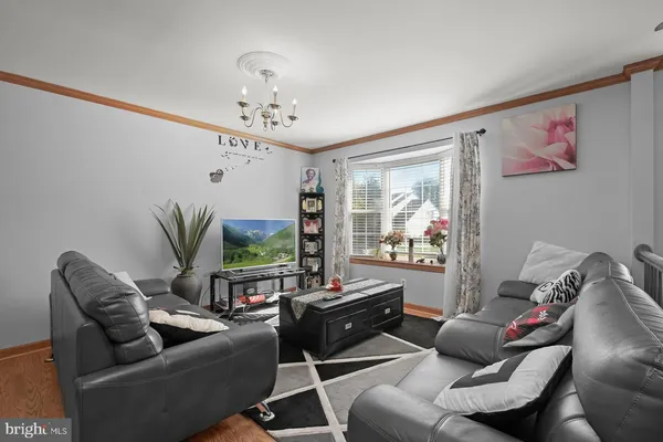 a living room with furniture ceiling fan and a window