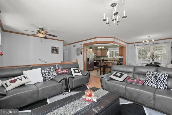 a living room with furniture and a chandelier