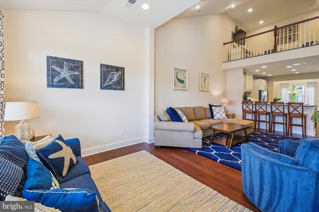a living room with furniture flat screen tv and a large window
