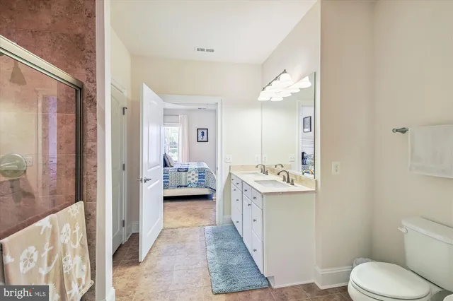 a utility room with dryer washer and a wooden floor
