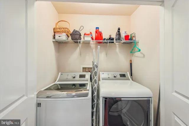 a bedroom with a bed and a lamp on dresser