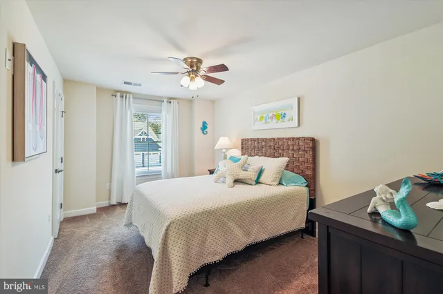 a bedroom with double bed and a chandelier