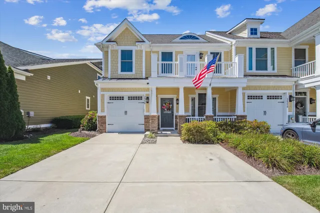 a view of a dining room with furniture a chandelier and wooden floor
