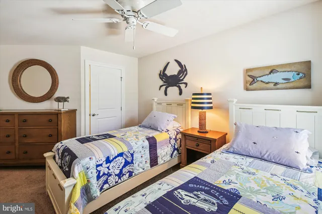 a front view of a multi story residential apartment building with yard and green space