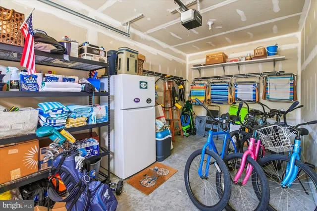 a patio with a table and chairs and potted plants