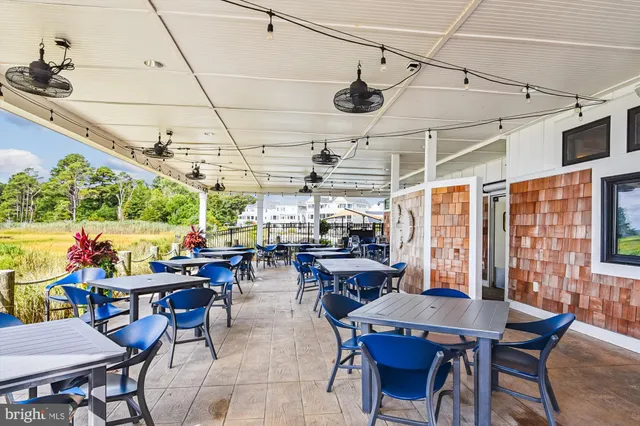 a view of a patio with table and chairs potted plants