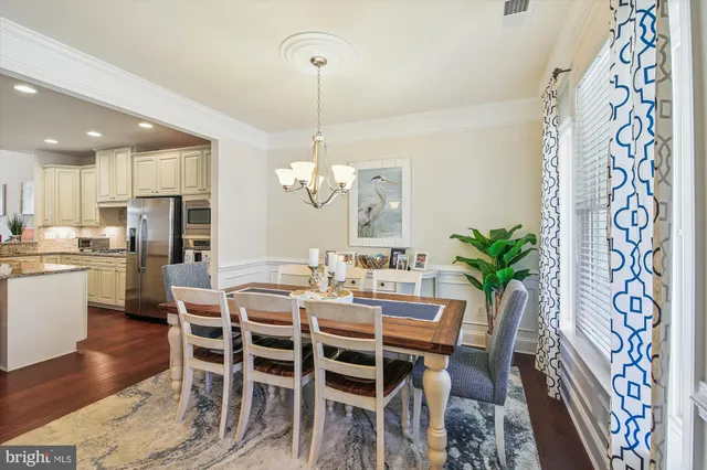 a kitchen with stainless steel appliances granite countertop a refrigerator a stove and a sink