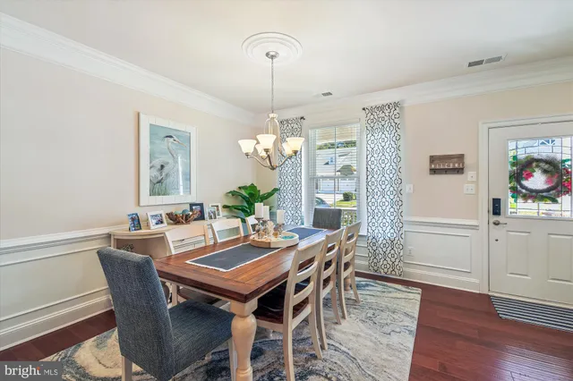 a kitchen with stainless steel appliances granite countertop a dining table chairs and granite counter tops