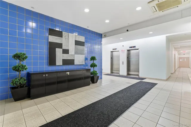 a lobby with a couch and potted plant