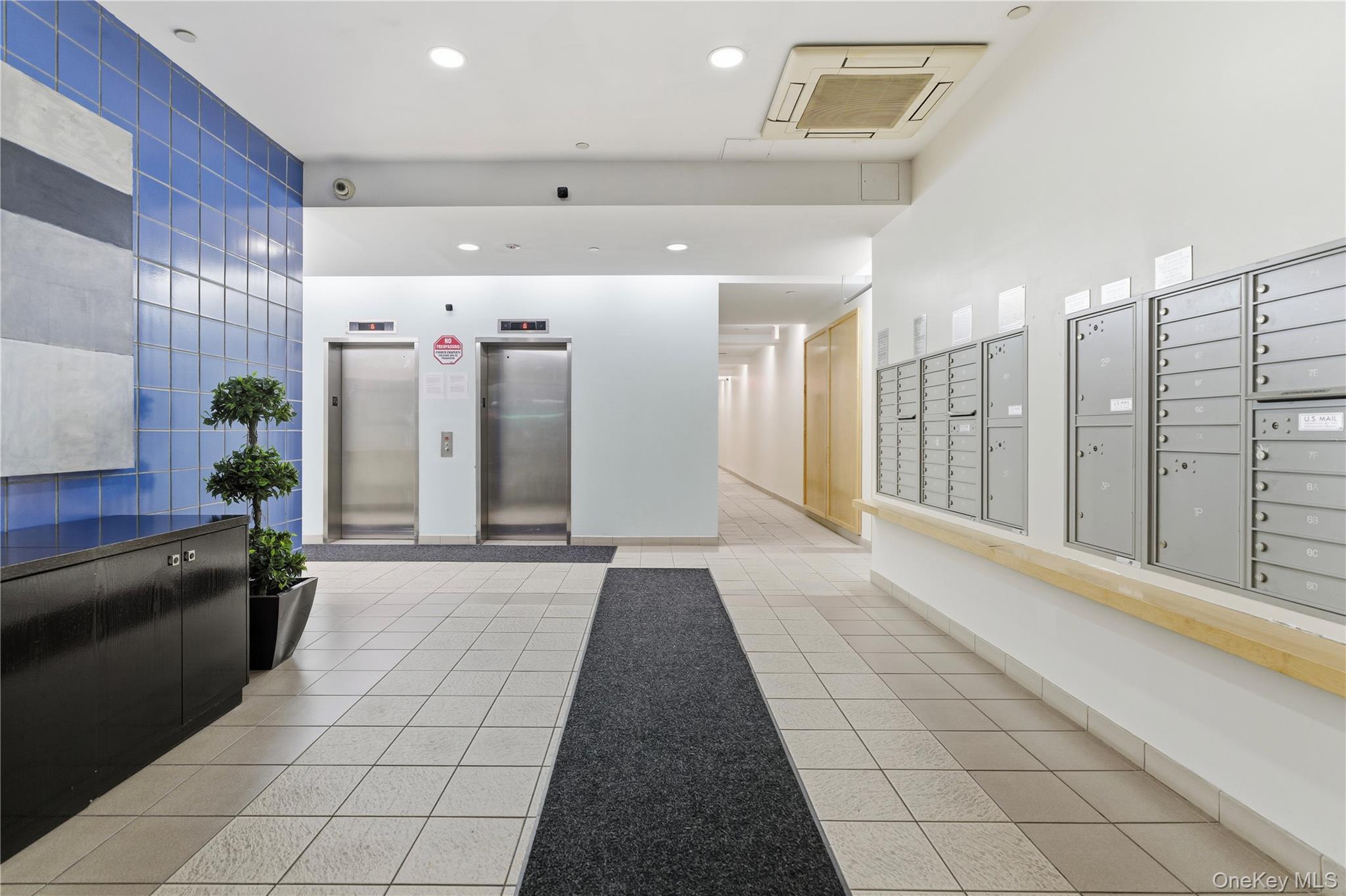 3044 3rd Avenue, Unit 9C Bronx, NY 10451 - Photo 4 of 15 Lobby with recessed lighting and tile walls