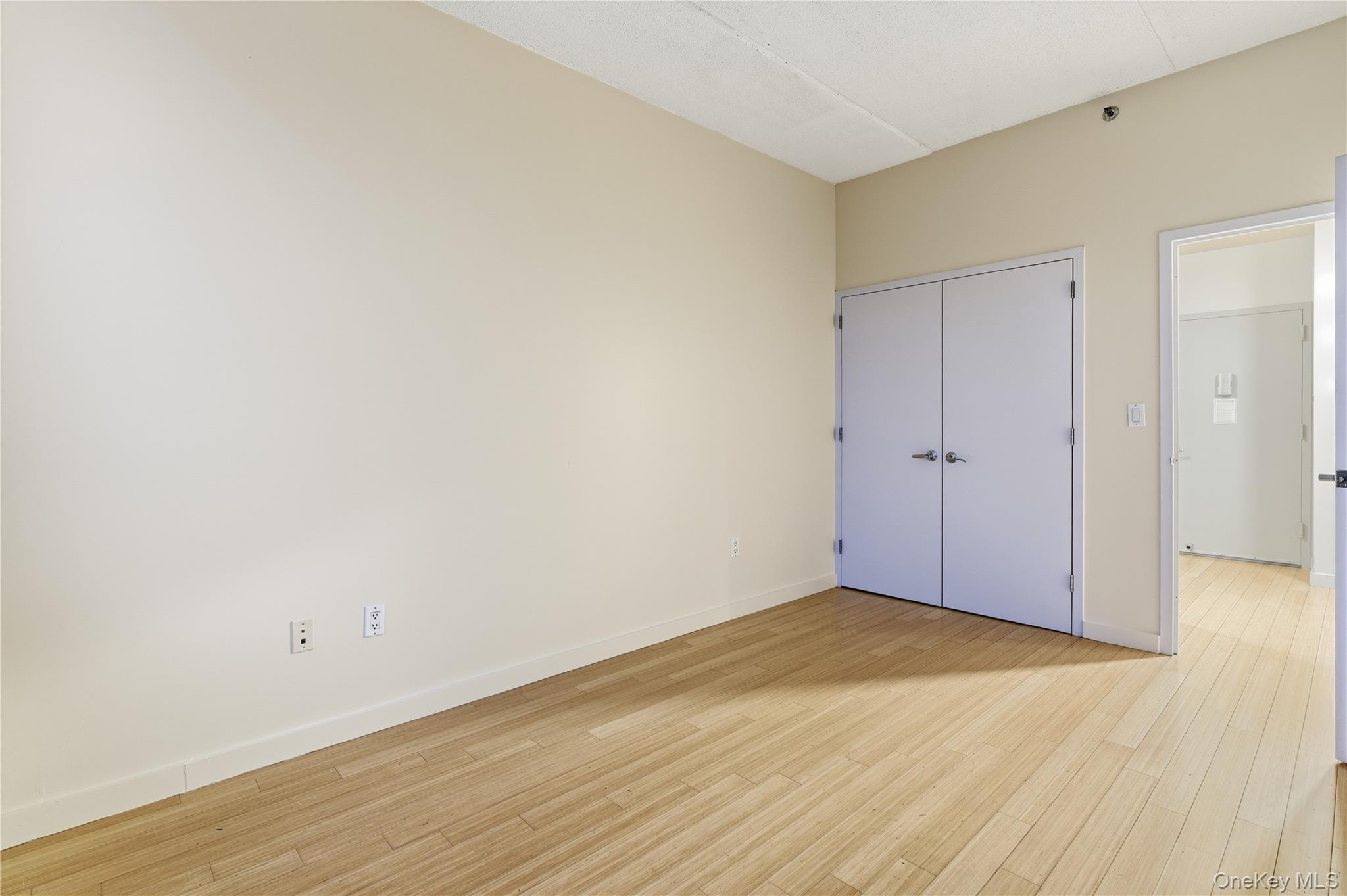 3044 3rd Avenue, Unit 9C Bronx, NY 10451 - Photo 6 of 15 Unfurnished bedroom featuring light wood-type flooring and a closet