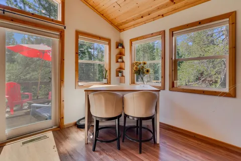 a view of a dining room with furniture large windows and wooden floor