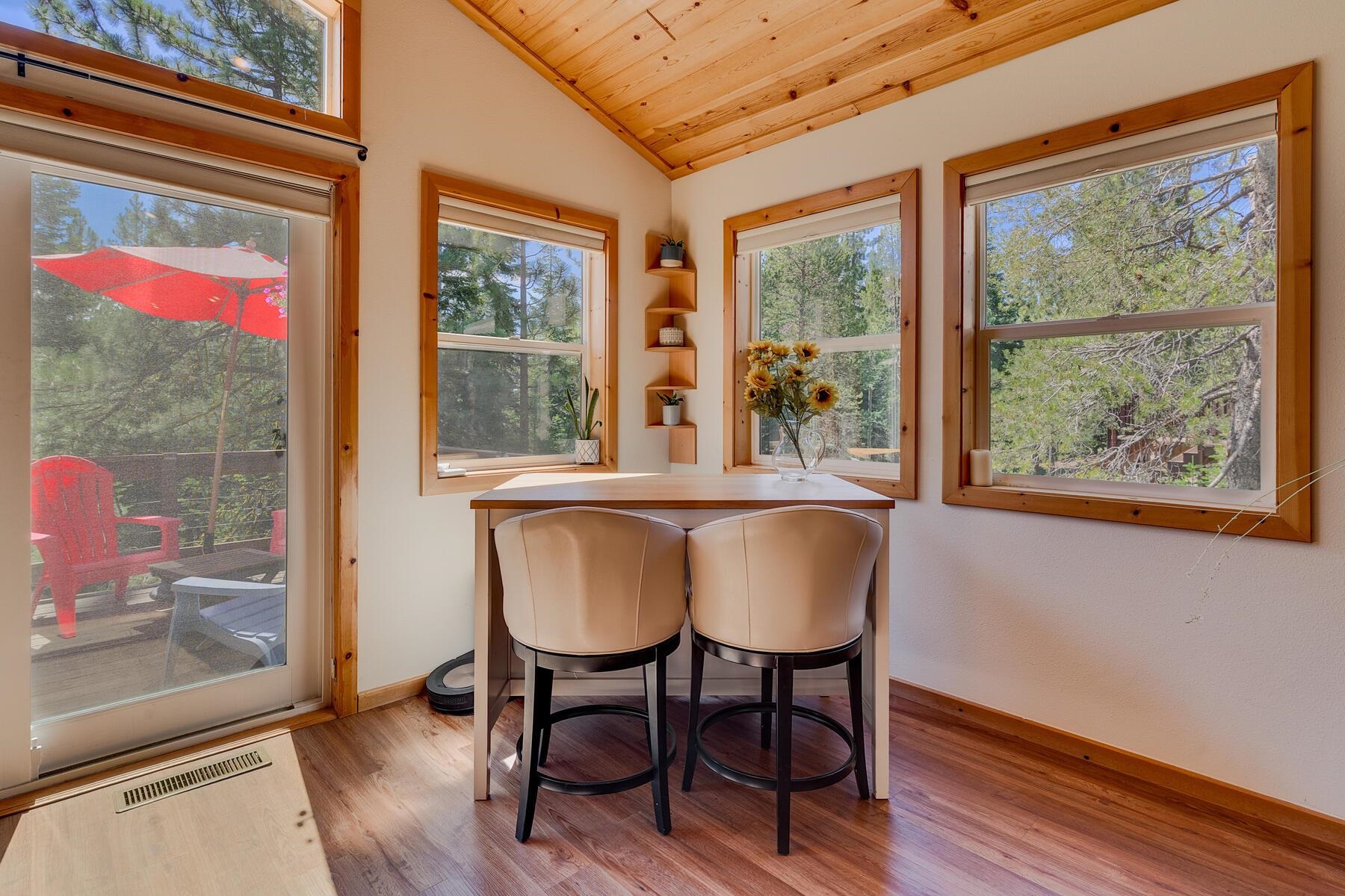 11511 Baden Road Truckee, CA 96161 - Photo 11 of 28 a view of a dining room with furniture large windows and wooden floor