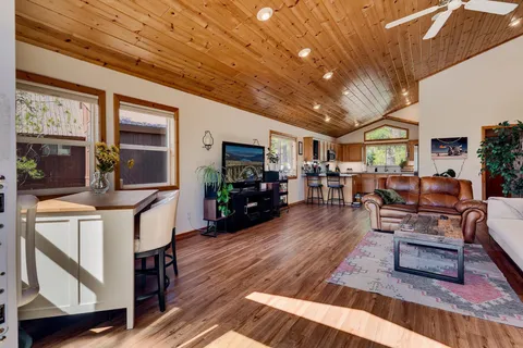 a living room with furniture and a wooden floor