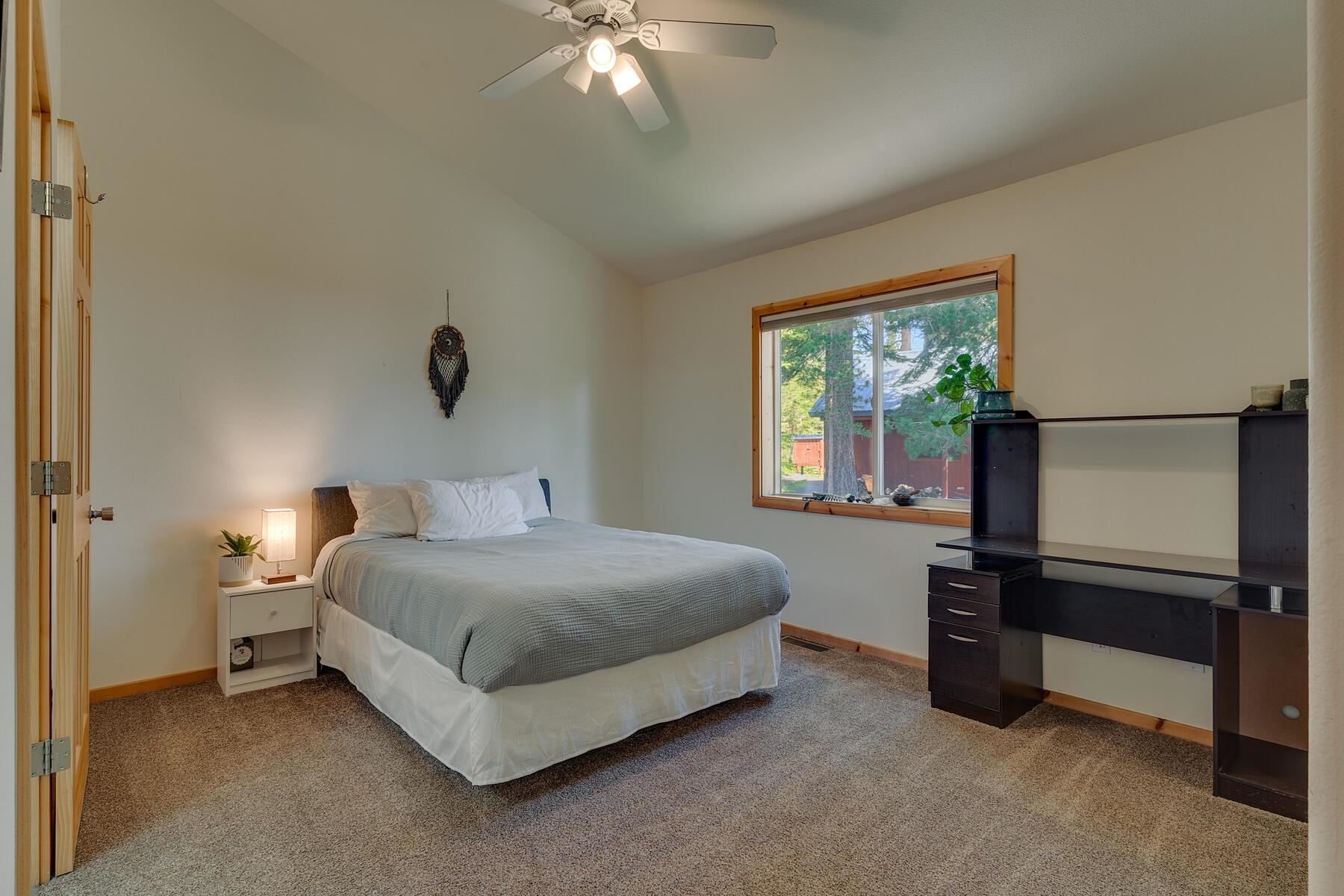 11511 Baden Road Truckee, CA 96161 - Photo 21 of 28 a bedroom with a bed and a chandelier