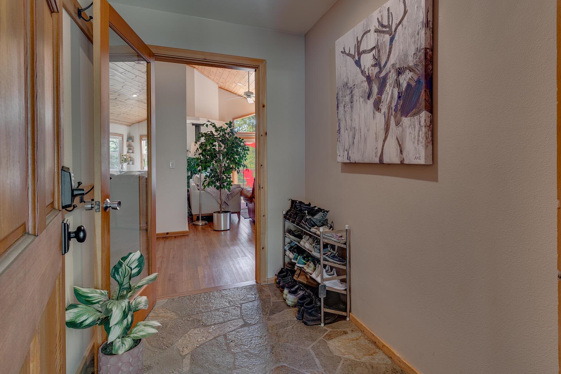 11511 Baden Road Truckee, CA 96161 - Photo 3 of 28 a hallway with a vase of flowers and wooden floor
