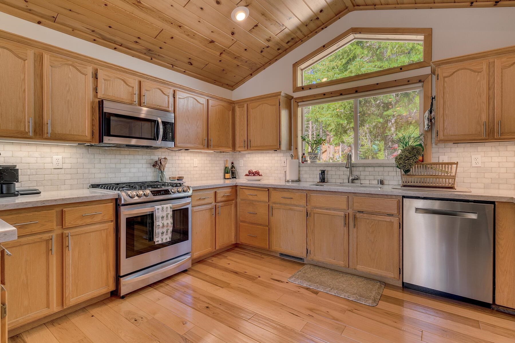 11511 Baden Road Truckee, CA 96161 - Photo 6 of 28 a kitchen with stainless steel appliances granite countertop a stove sink microwave and window