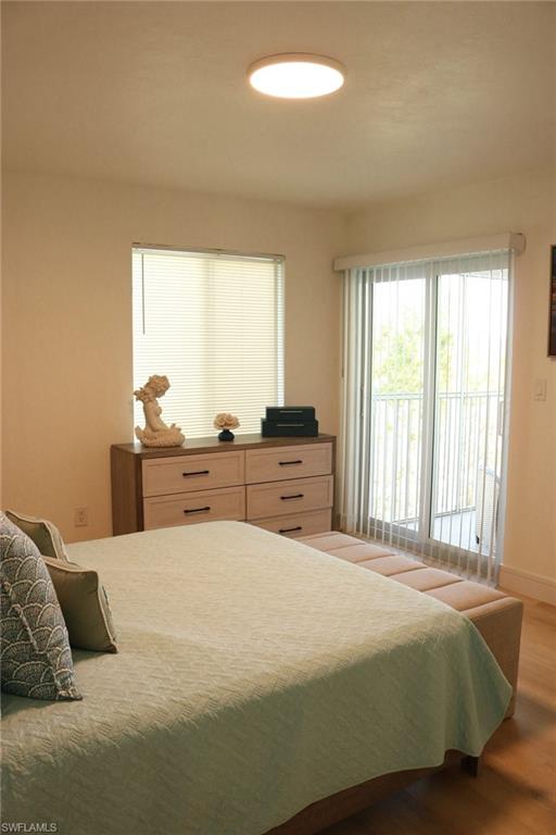 2235 San Marco Road, Unit 5204 Marco Island, FL 34145 - Photo 16 of 34 Spacious room featuring wood-finish flooring, a contemporary flush-mount ceiling light, and a window with horizontal blinds