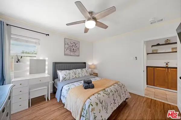 a bedroom with a bed and wooden floor