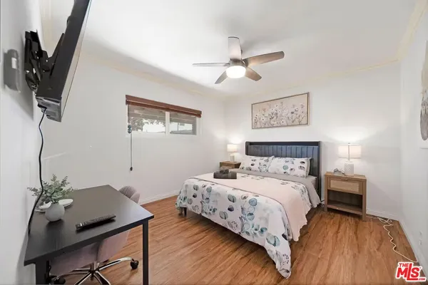 a bedroom with a bed and a desk