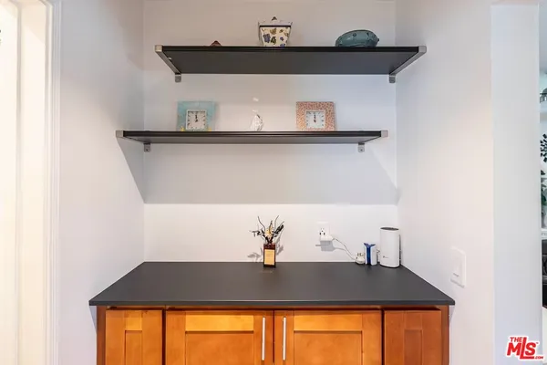 a close view of kitchen sink with cabinets