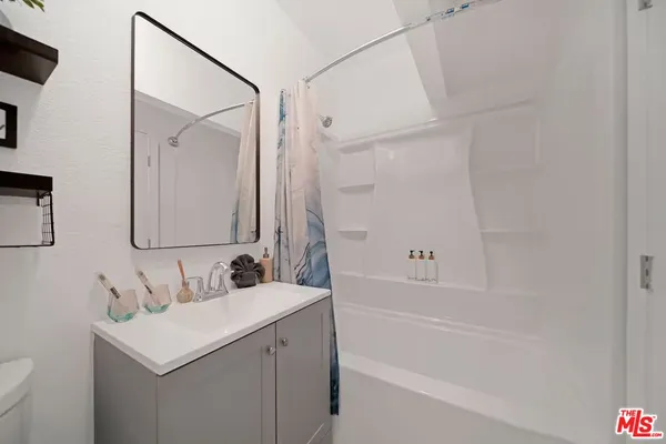 a bathroom with a sink toilet tub and shower