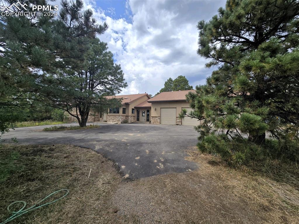 15850 Siesta Grove Colorado Springs, CO 80908 - Photo 2 of 4 a front view of a house with a yard and trees
