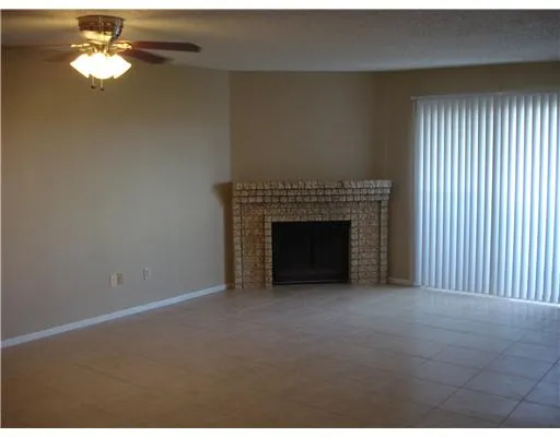 a view of empty room with a fireplace