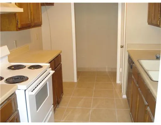 a bathroom with a granite countertop sink a washer and dryer