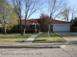 6015 Elmhurst Road Amarillo, TX 79106 - Photo 1 of 15 a house with trees in front of it