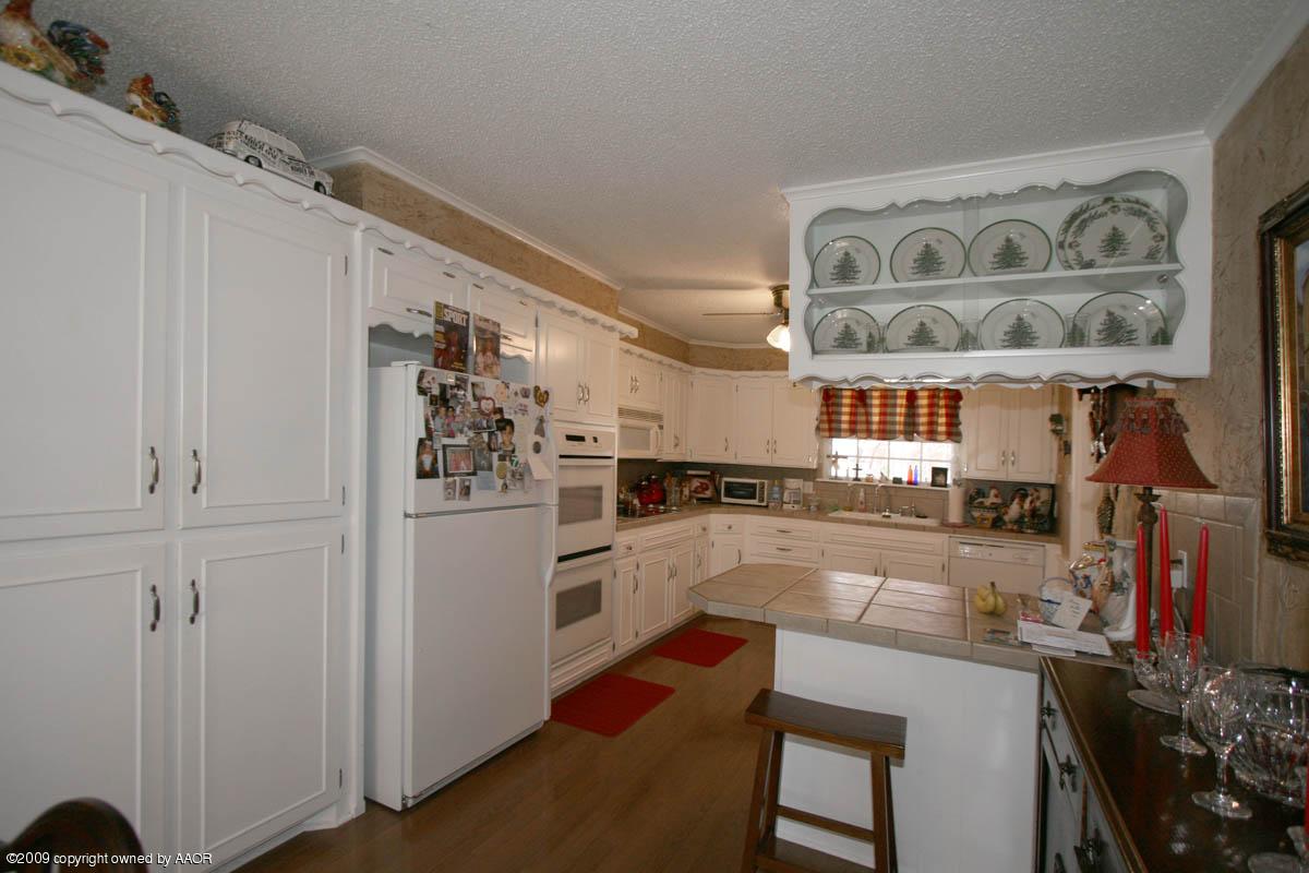 6015 Elmhurst Road Amarillo, TX 79106 - Photo 9 of 15 a kitchen with stainless steel appliances granite countertop a sink and cabinets