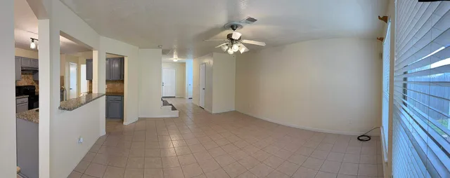 a view of a hallway with wooden floor and a chandelier