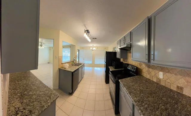 a large bathroom with a tub a sink and a large mirror