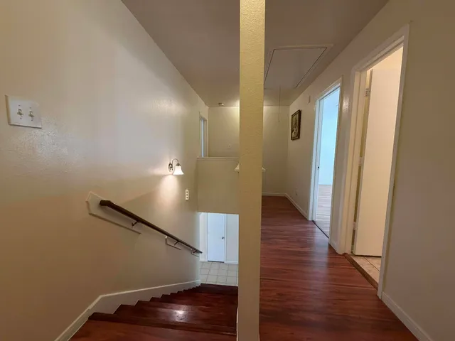 a view of a hallway with wooden floor