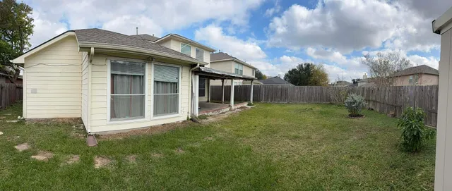 a view of house with backyard