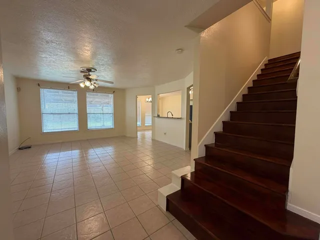 a view of an entryway with wooden floor and staircase