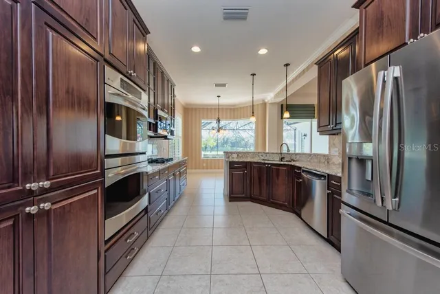 a kitchen with stainless steel appliances and double cabinets