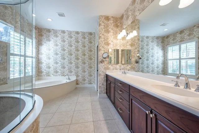 an empty room with a window and a ceiling fan