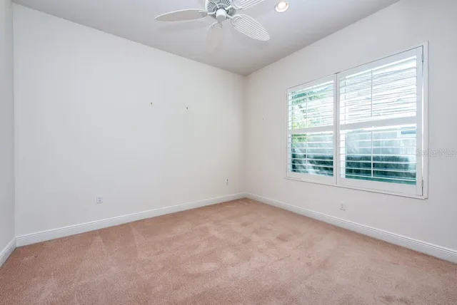 a living room with a floor to ceiling window and wooden floor