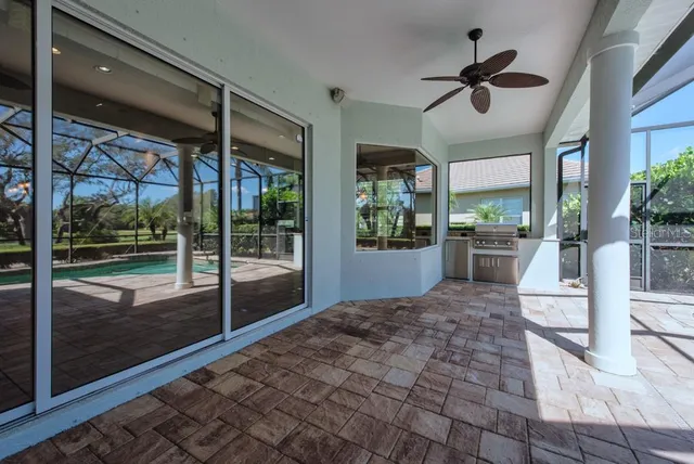 a patio with a table and chairs and potted plants