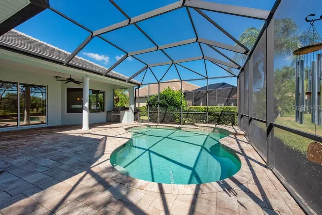 a view of a patio with a table and chairs under an umbrella