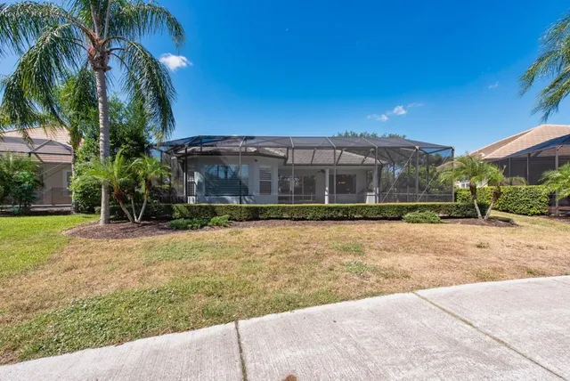 a view of a house with a yard and a garage