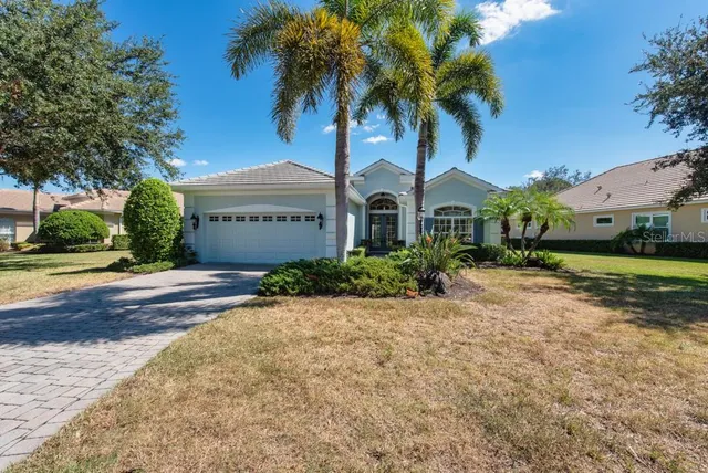 an aerial view of residential houses with outdoor space and river