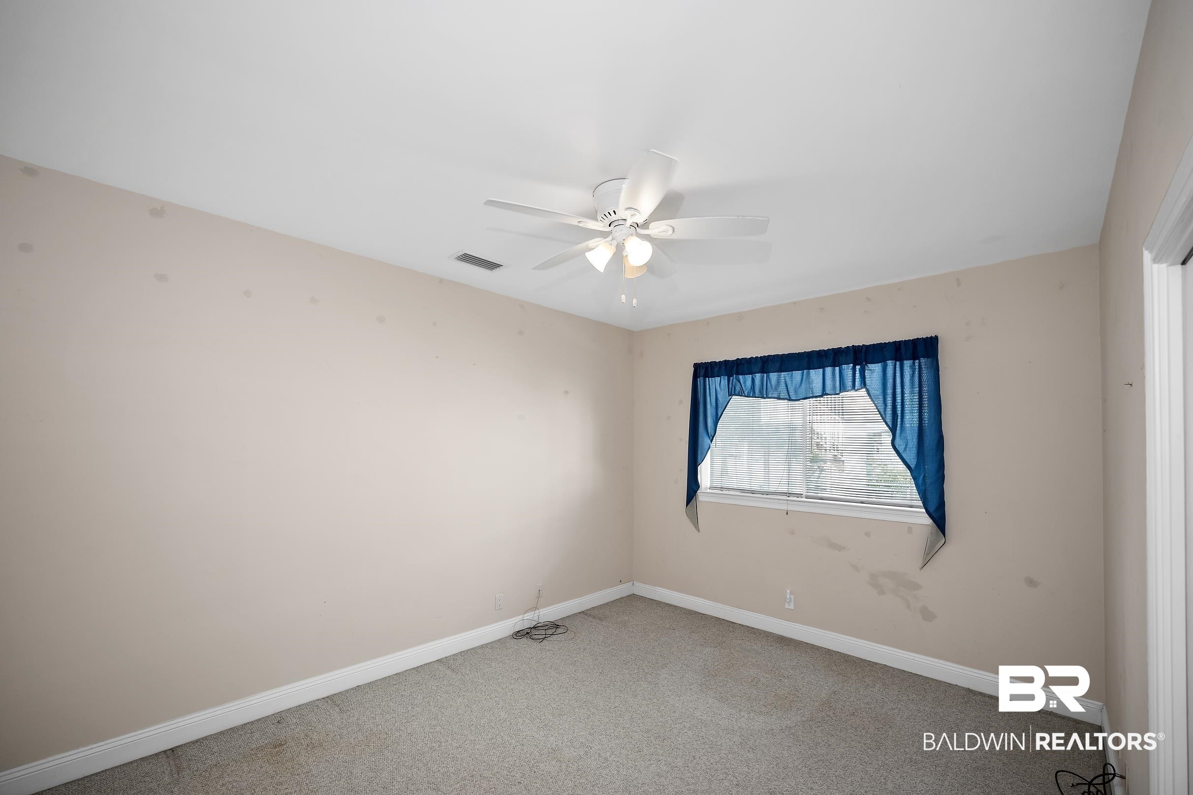 8591 Bay Harbor Road Elberta, AL 36530 - Photo 39 of 56 Empty room featuring carpet and a ceiling fan