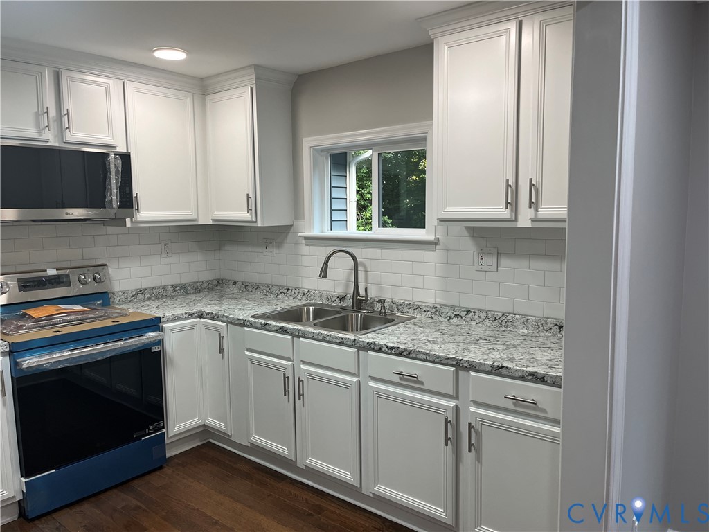 3074 Rocky Ford Road Crewe, VA 23930 - Photo 16 of 48 Kitchen featuring white cabinetry, subway tile bac