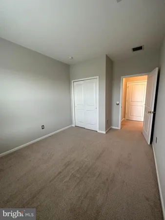 a view of an empty room and a window