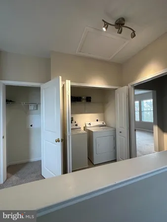 a kitchen with a refrigerator and cabinets