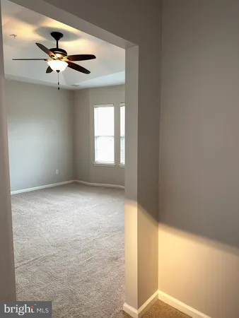 a view of a livingroom with a ceiling fan and window
